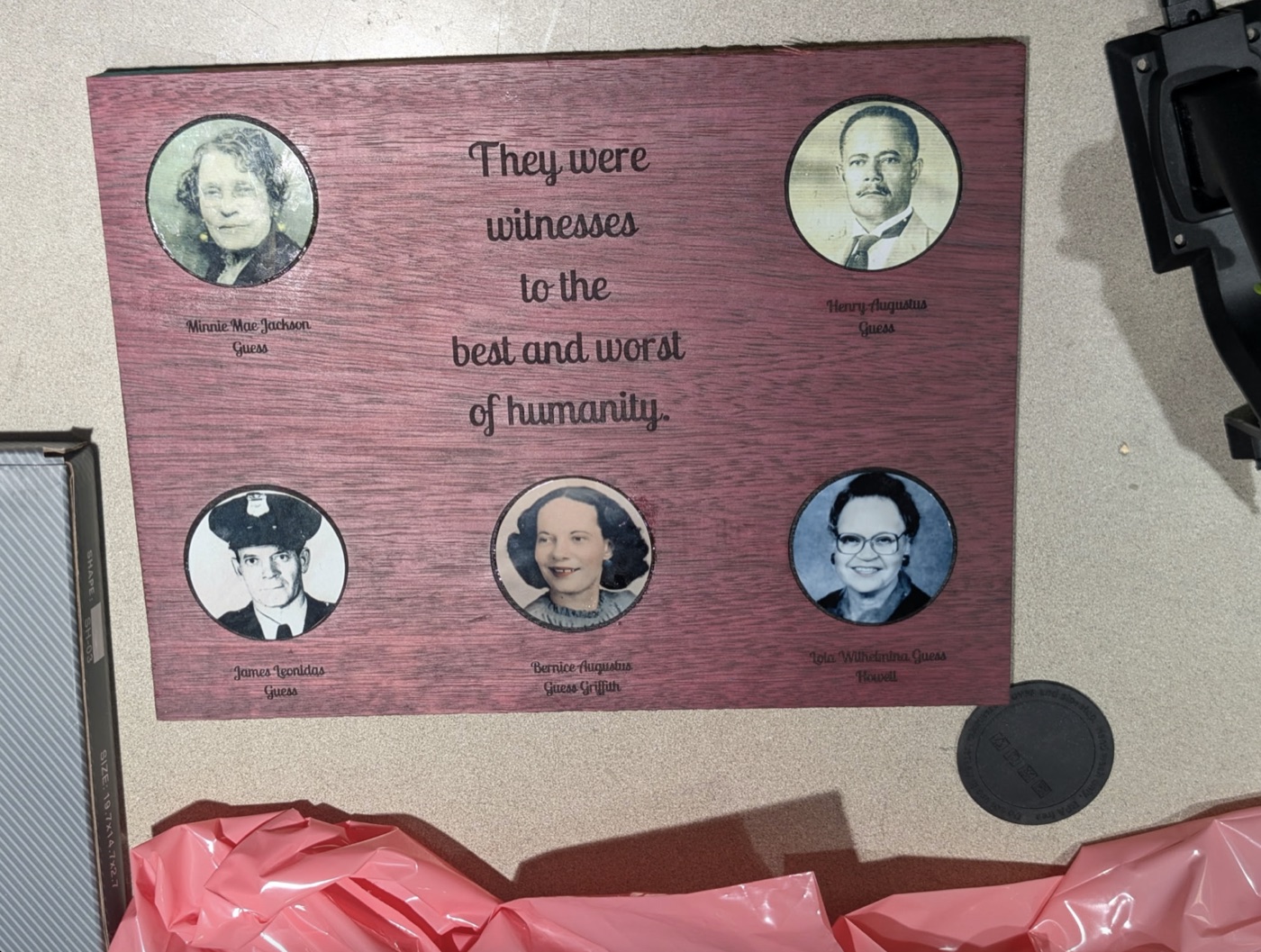 Family memorial plaque with five portraits, titled “They were witnesses to the best and worst of humanity.”